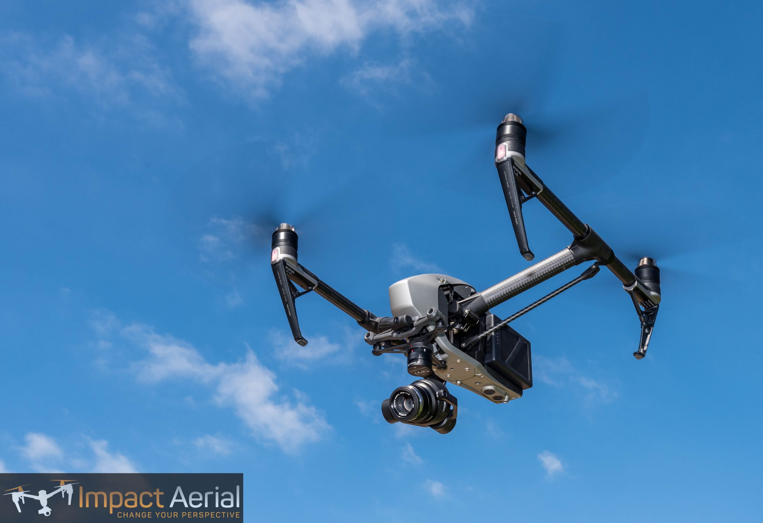 DJI Inspire 2 drone in flight against a blue sky